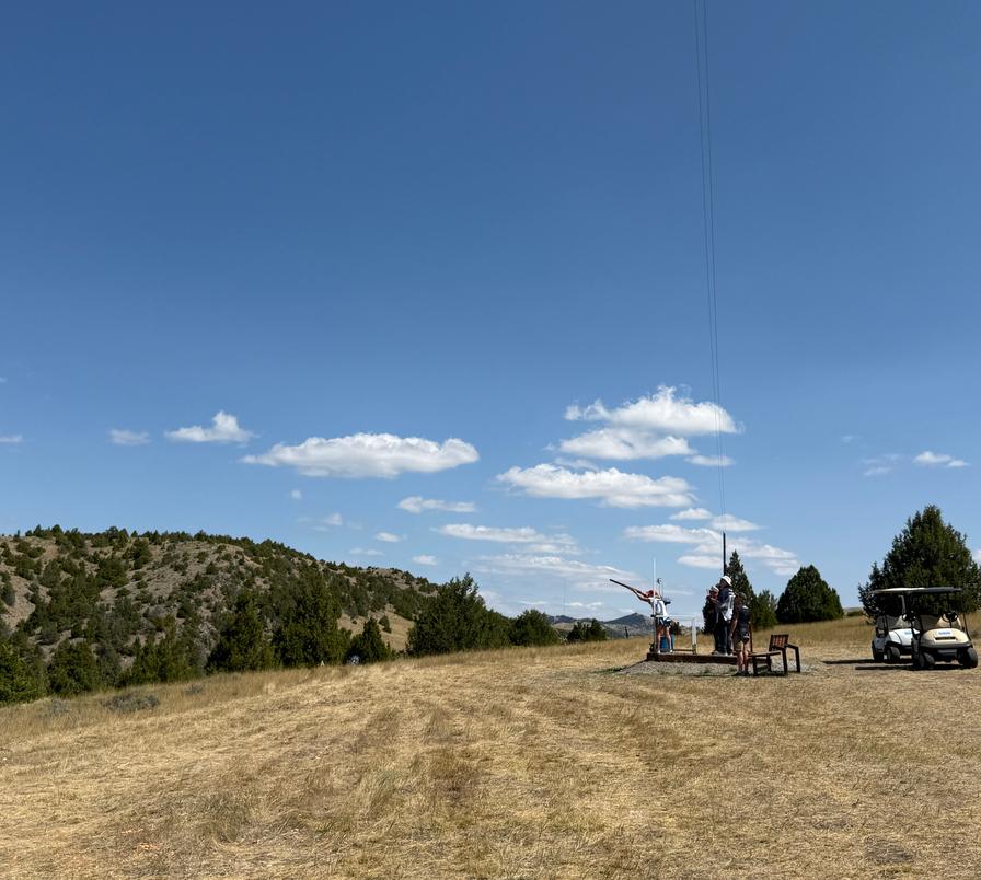 Shooters with Montana hillside backdrop