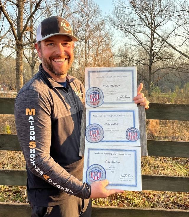 Cody Matson holding his certifications