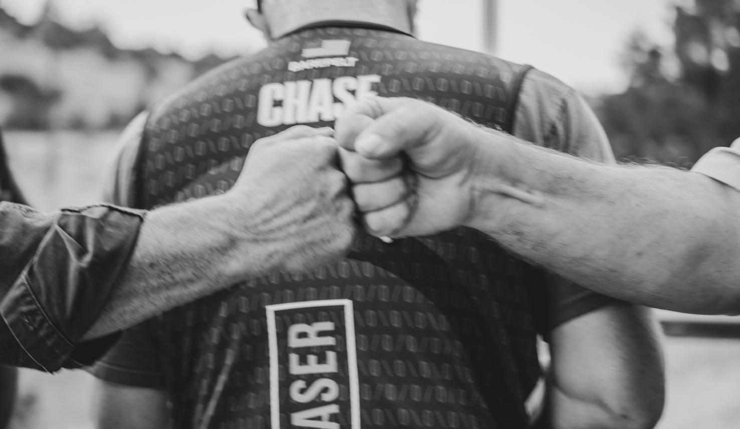 Two shooters fist bump at The Western Challenge sporting clays shoot