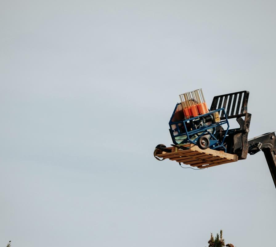 A hoisted clay target thrower throwing a clay target