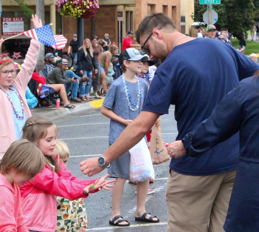 Eager little hands reach for candy.