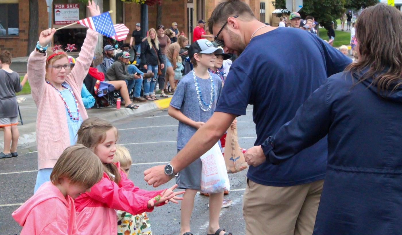 Eager little hands reach for candy.