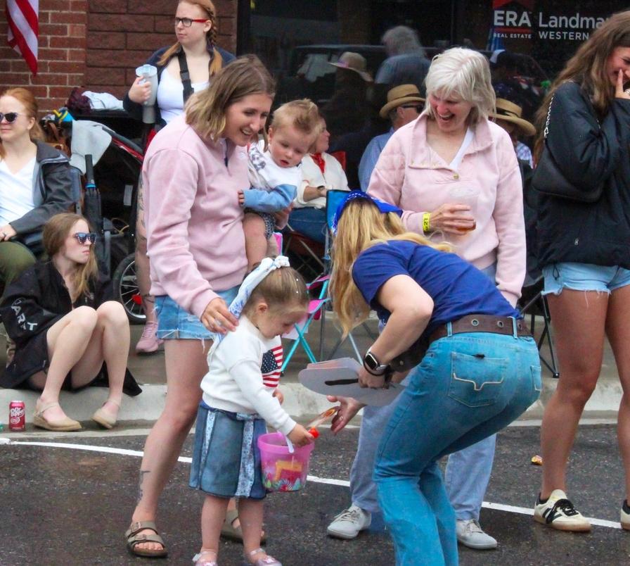 Chelsey hands out Jay fans.