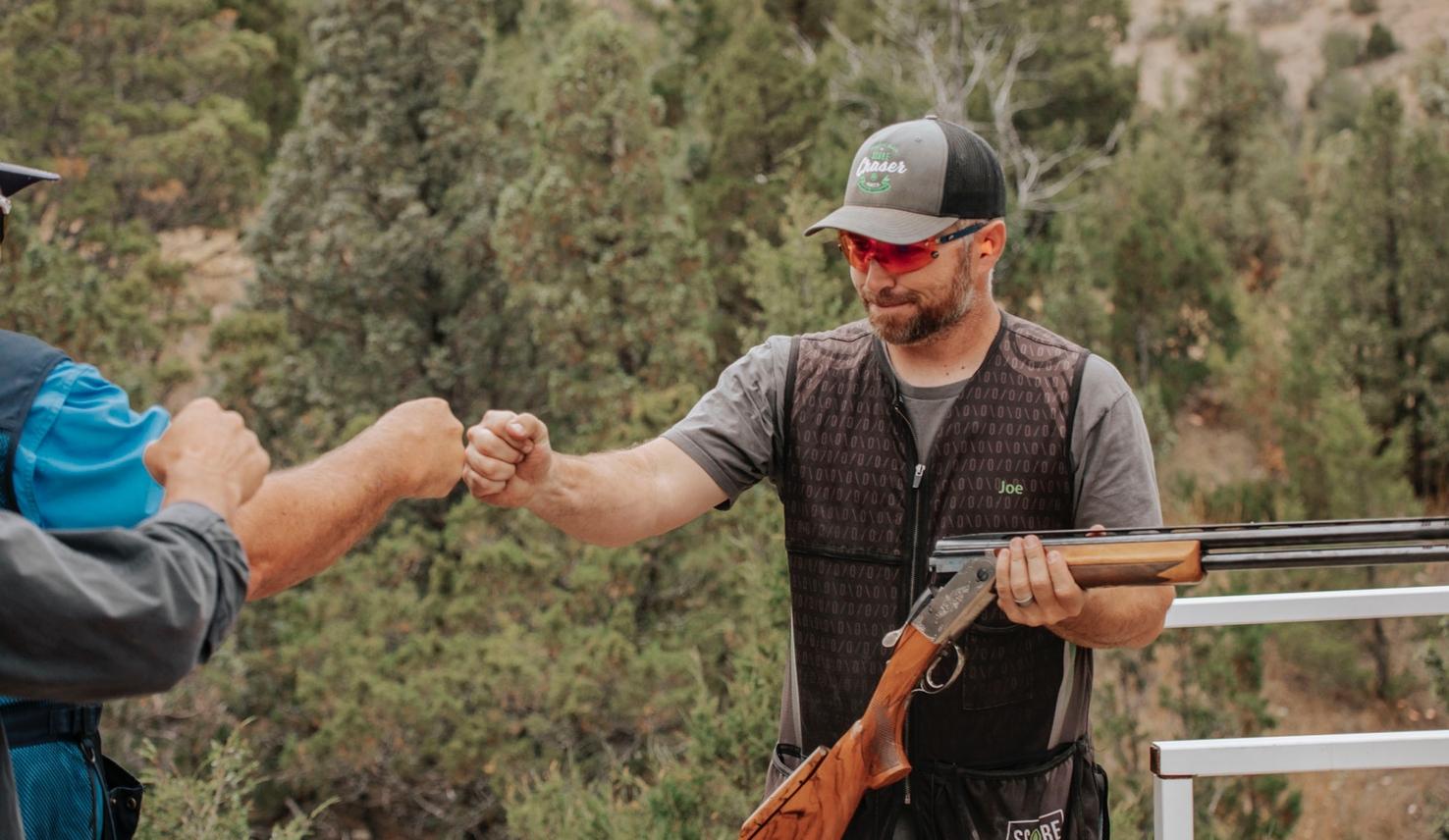 Shooter fist bumps team members